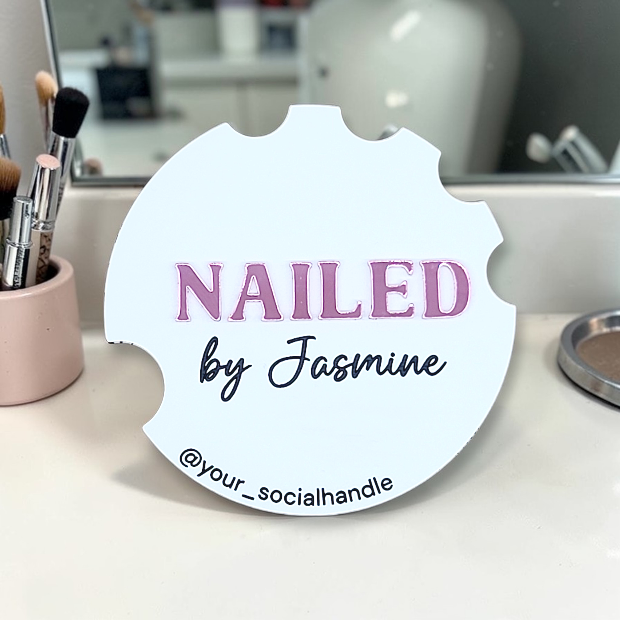 White Nailfie Disc with pink NAILED lettering, by Jasmine, and a social media handle